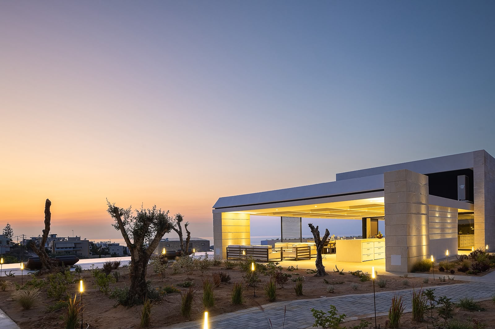 Villa KORA's illuminated outdoor pavilion at sunset