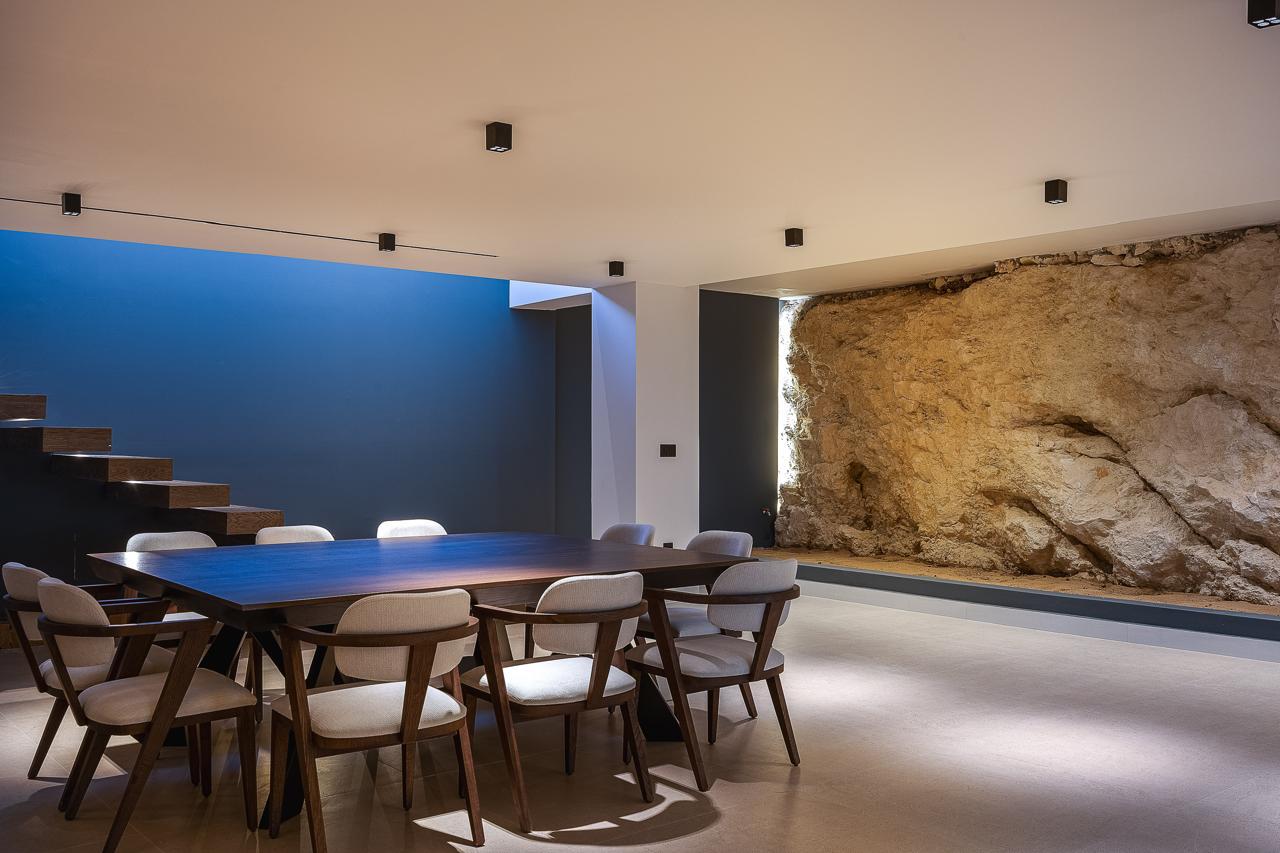 The excavated rock face lit along the length of the entertainment room