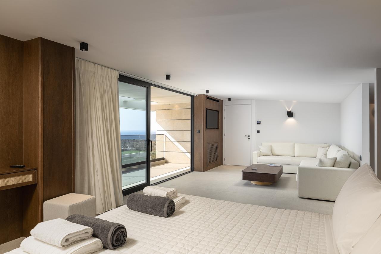 Lounge seating in the primary suite beside the terrace doors